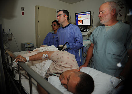 460px-US_Navy_110405-N-KA543-028_Hospitalman_Urian_D._Thompson,_left,_Lt._Cmdr._Eric_A._Lavery_and_Registered_Nurse_Steven_Cherry_review_the_monitor_whil